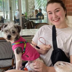 woman in white shirt with small grey dog