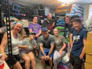 Group of people sitting in a storage room