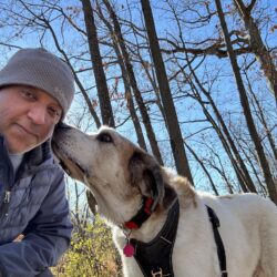 man in hat with white dog