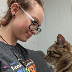 woman in grey shirt and glasses with brown cat